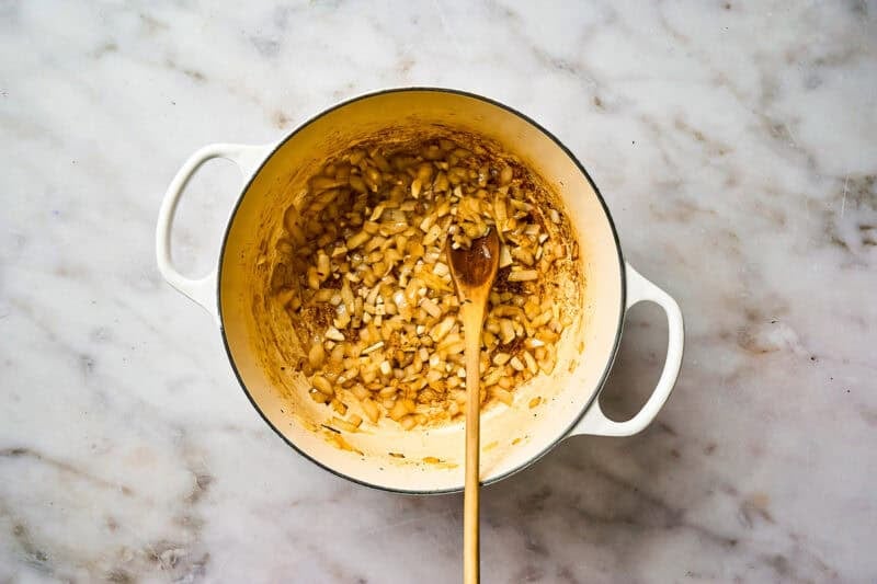 Sautéing onions in a pot.