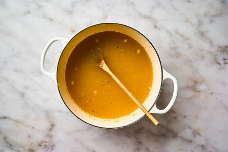 Building soup broth in a pot.