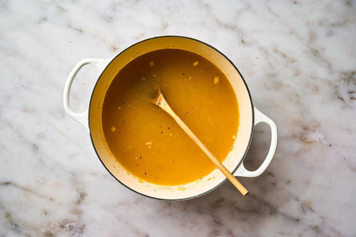 Building soup broth in a pot.