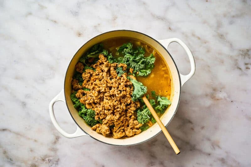 Ground chicken and kale added to soup broth.