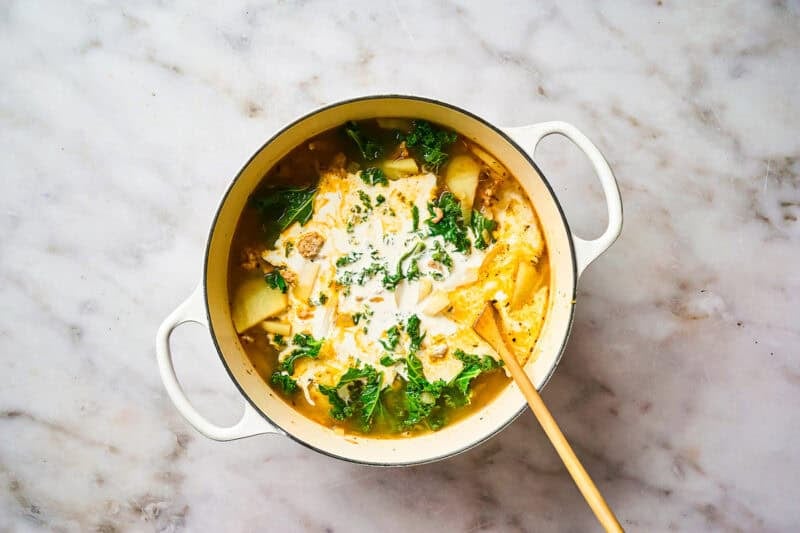 Cream added to pot of soup.