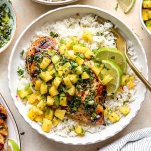 Mojito marinated chicken and mint sauce served with rice and salsa.