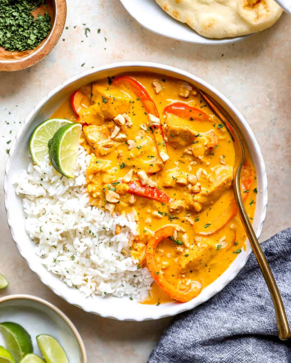 A bowl of chicken pumpkin curry with rice.