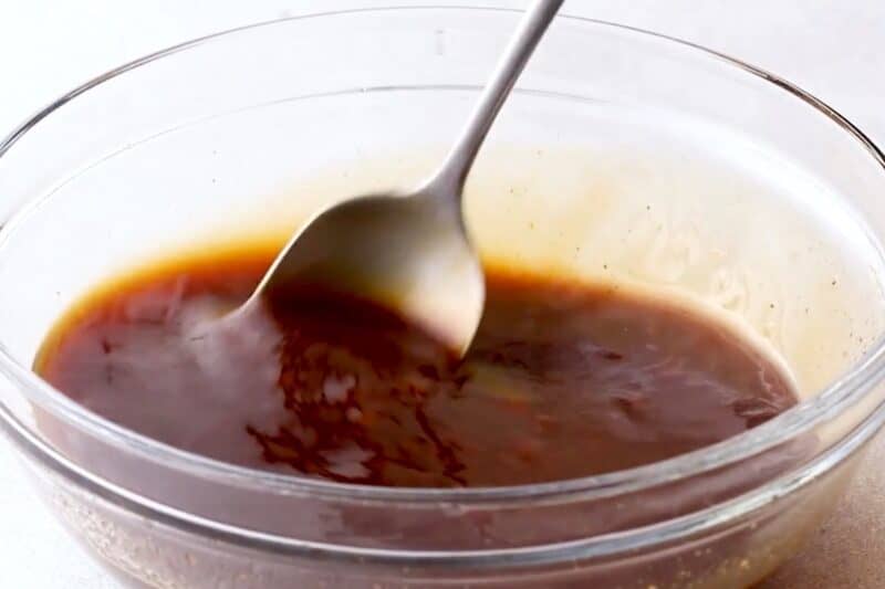 Mixing tonkatsu sauce in a bowl.