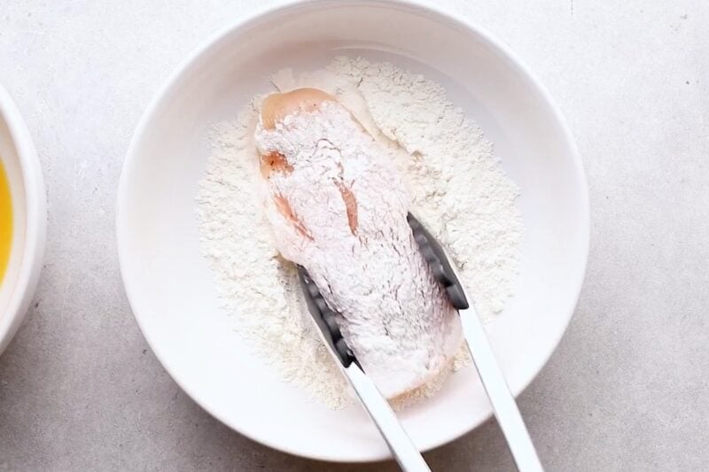 Dredging cutlet in flour.