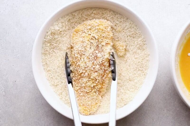 Dredging cutlet in panko breadcrumbs.